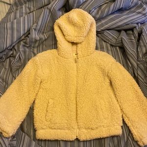 This is a white furry sweater for the winter . The brand is RSQ from Tilly’s.